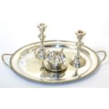 A silver plated tray, a pair of dwarf candlesticks and a plated sugar and basin