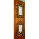 A pair of brass decorative mirrors