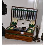Silver handled knives, silver cigarette case, pair of candlesticks and a canteen of plated cutlery