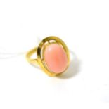 A coral ring, finger size PRing stamped '750'. 4.10g