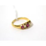 An 18ct gold ruby and diamond ring, total estimated diamond weight 0.20 carat approximately,