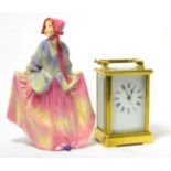 A brass carriage timepiece and a Royal Doulton china figure 'Sweet Anne' HN1331