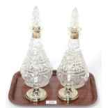 A pair of silver collared decanters by Mappin & Webb together with a pair of modern filled silver