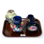 Four pieces of Walter Moorcroft pottery, Spring flowers ginger jar and cover, two vases in the