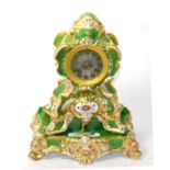 A green porcelain and floral decorated striking mantel clock, raised upon a matching porcelain stand