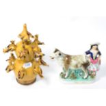 A 19th century Staffordshire pottery cow group and folk pottery bird money box Money box with