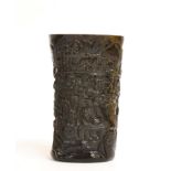 A Chinese Carved Bovine Horn Libation Cup, carved with figures amongst pine and bamboo, bears four