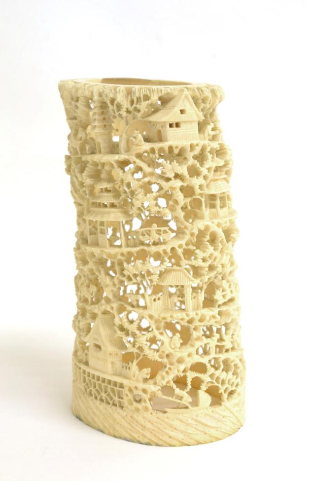 A Cantonese Ivory Tusk Vase, 19th century, intricately carved and pierced with figures amongst