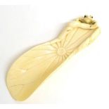 A Japanese Carved Ivory Brush Rest, Meiji period, as a lily pad with a toad clambering over the rim,