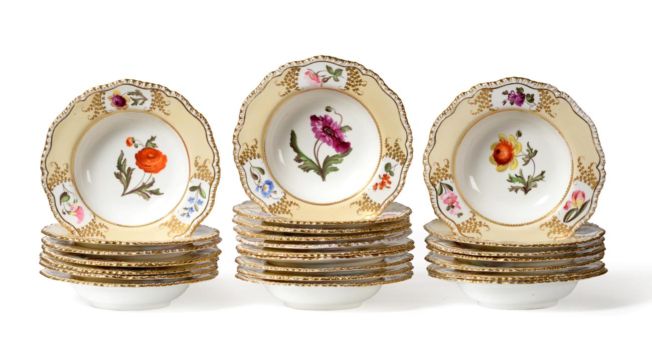 A Set of Twenty-Four Coalport Porcelain Soup Plates, circa 1815, painted with flower sprigs within