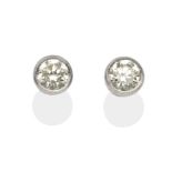 A Pair of Diamond Solitaire Earrings, a round brilliant cut diamond in a white milgrain setting,