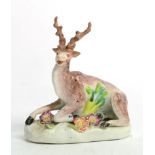 A Derby Porcelain Figure of a Stag, circa 1770, recumbent on a mound base, 10cm long; and A Bow