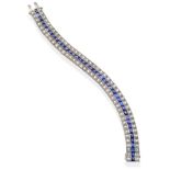 A Synthetic Sapphire and Diamond Bracelet, set with calibré cut sapphires within two rows of round