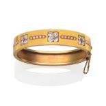 A Diamond and Seed Pearl Bangle, inset with three clusters of five old cut diamonds in yellow claw