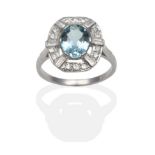 An Aquamarine and Diamond Cluster Ring, an oval cut aquamarine in a white claw setting within a