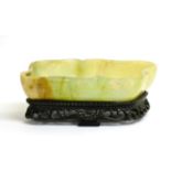 A Chinese Jade Brush Washer, of lobed rectangular form, 20cm long, on hardwood stand