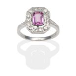 A Pink Sapphire and Diamond Cluster Ring, an emerald-cut pink sapphire within a conforming border of