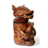 A Treacle Glazed Pottery Bear Jug and Cover, early 19th century, naturalistically modelled sitting
