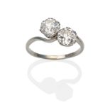 A Diamond Two Stone Twist Ring, two old cut diamonds in white double claw settings, to twist