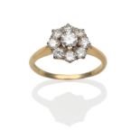 A Diamond Cluster Ring, a round brilliant cut diamond within a border of smaller round brilliant cut