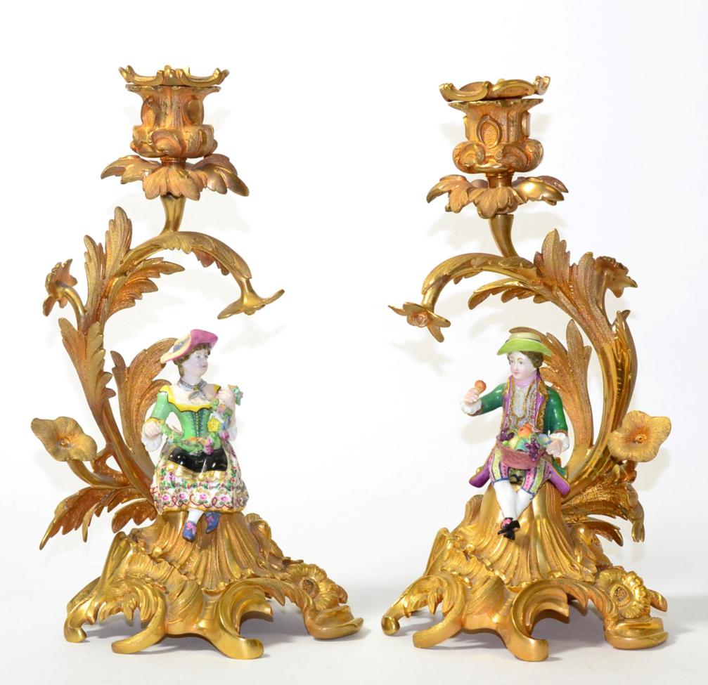 A Pair of Minton Porcelain and Ormolu Candlesticks, circa 1860, as a boy and girl holding fruit