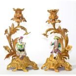 A Pair of Minton Porcelain and Ormolu Candlesticks, circa 1860, as a boy and girl holding fruit