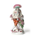 A Bow Porcelain Figure of a Shepherd, circa 1765, leaning against a tree trunk playing pipes, his