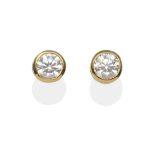 A Pair of Diamond Solitaire Earrings, a round brilliant cut diamond in a yellow milgrain setting,