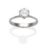 A Diamond Solitaire Ring, a round brilliant cut diamond in a white claw setting, to knife edge