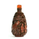A Chinese Cinnabar Lacquer Snuff Bottle and Stopper, Qing Dynasty, of pear form, carved with figures