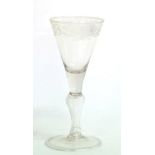 A Light Baluster Wine Glass, circa 1750, the funnel bowl engraved with a band of scrolling