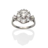 A Diamond Cluster Ring, an old cut diamond within a border of smaller old cut diamonds in white claw