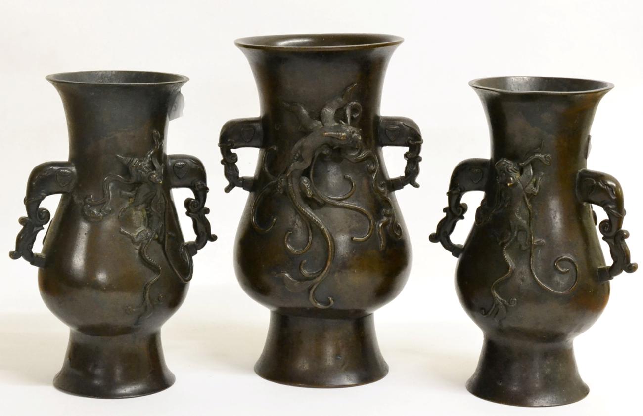 A Garniture of Three Chinese Bronze Vases, bears Xuande reign mark, of flattened baluster form