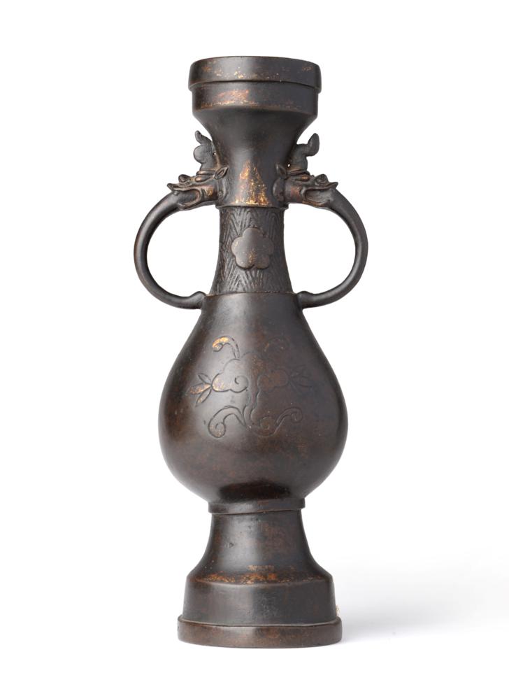 A Chinese Bronze Vase, possibly Ming Dynasty, of Hu form cast with dragon's mask and scroll handles,