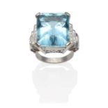 An Art Deco Aquamarine and Diamond Ring, an emerald-cut aquamarine in a white claw setting and set