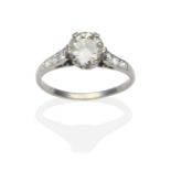 A Diamond Solitaire Ring, an old cut diamond in a white double claw setting to shoulders each set