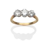 A Diamond Three Stone Ring, three round brilliant cut diamonds in white claw settings, on a yellow