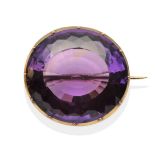 A Large Amethyst Brooch, an oval cut amethyst in a yellow collet and claw setting, measures 3.2cm by