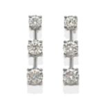 A Pair of Diamond Earrings, three graduated round brilliant cut diamonds in white claw settings