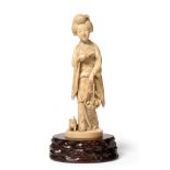A Japanese Ivory Okimono of a Girl, Meiji period, standing wearing traditional flowing robes holding
