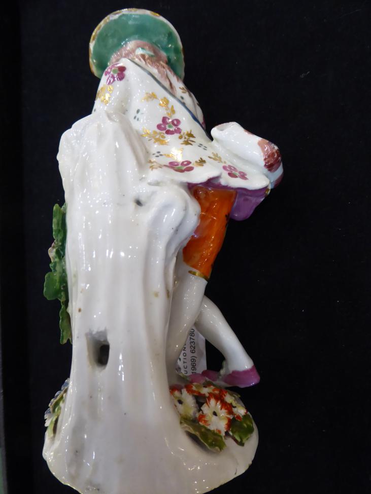 A Bow Porcelain Figure of a Shepherd, circa 1765, leaning against a tree trunk playing pipes, his - Image 3 of 4