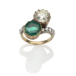 An Emerald and Diamond Two Stone Twist Ring, an octagonal step cut emerald and an old brilliant