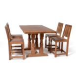 A Set of Four Sid Pollard Oak Panel Back Dining Chairs, on two octagonal front legs, joined by