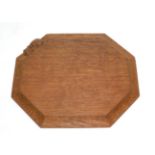 A Robert ''Mouseman'' Thompson Oak Bread Board, with carved mouse signature, 31cm; and A Robert ''