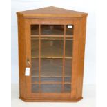 An Alan Grainger Acorn Industries Glazed Oak Hanging Corner Cupboard, with three fixed shelves, with