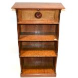 An Arts and Crafts Oak Bookcase, the over hanging rectangular top above a cupboard with fall front