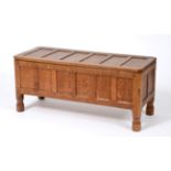 A Robert ''Mouseman'' Thompson Panelled Oak Blanket Box, on four octagonal feet, with carved mouse