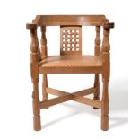 A Robert ''Mouseman'' Thompson Oak Monk's Chair, with curved back and shaped arms, over three