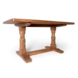 A Robert ''Mouseman'' Thompson Oak 5ft Refectory Table, on two octagonal legs, joined by a floor