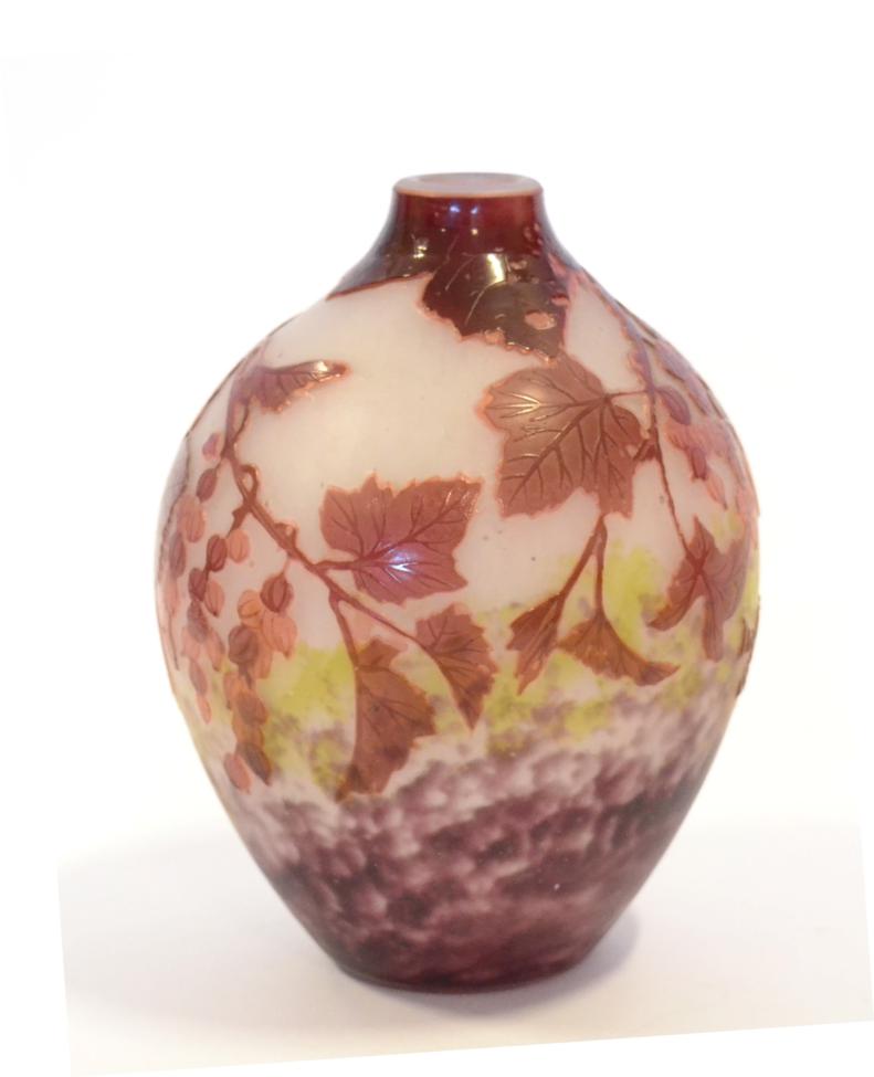 An André Delatte Cameo Glass Vase, in mottled green/purple overlaid with crimson, cut with hanging